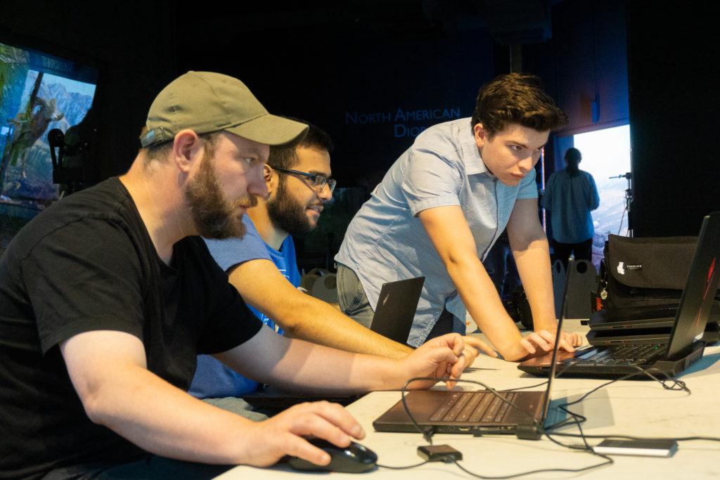 Justin, Farid, and Max all working on the laptops that were brought.